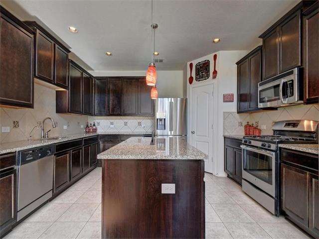 Huge kitchen with upgraded dark cabinetry, granite