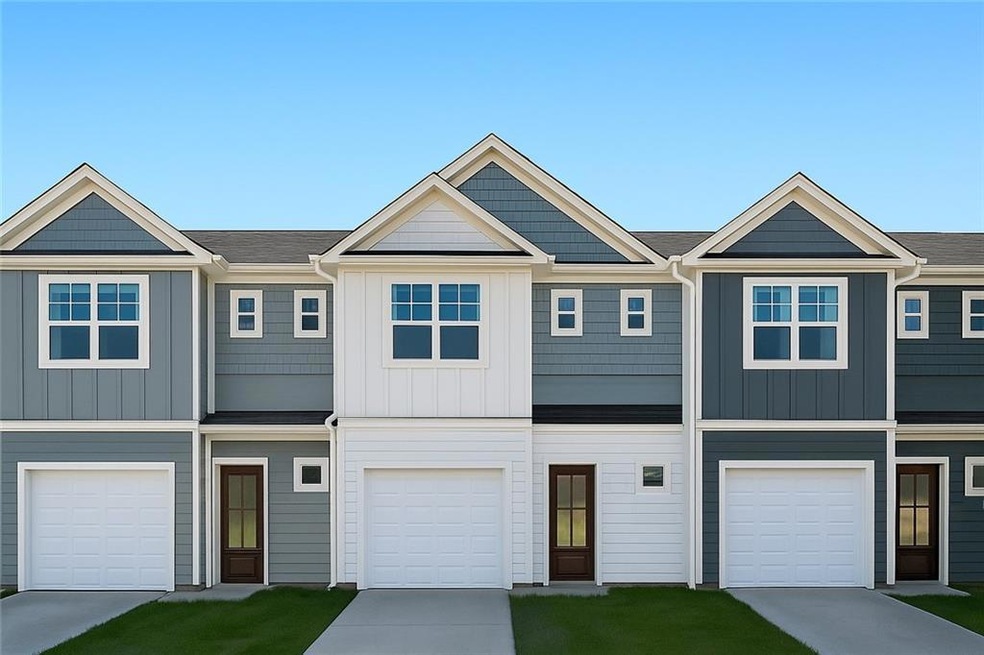 View of front of home featuring board and batten siding and concrete driveway