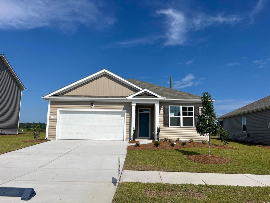 View of front facade with a garage and a front yar