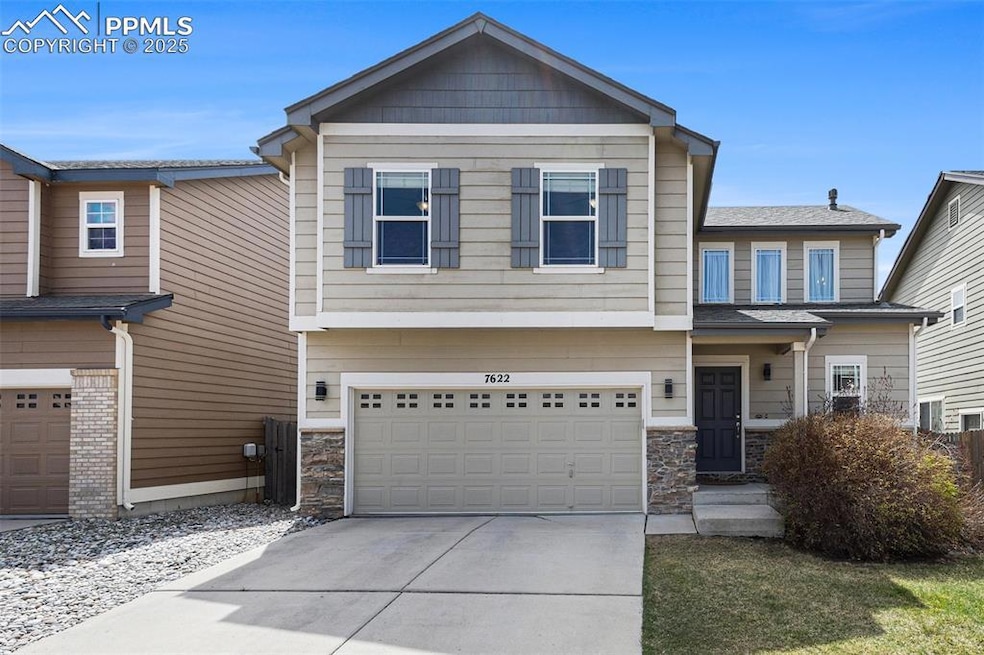 Craftsman house with a garage, stone siding, and concrete driveway
