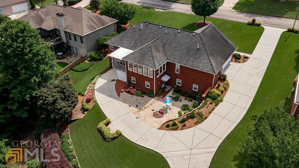 Back yard with drive around drive way, rock garden