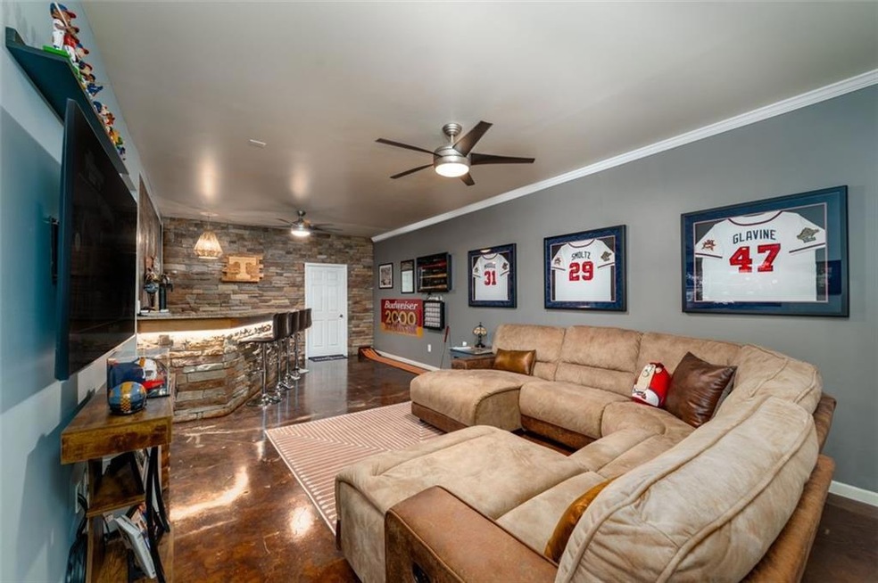 Living room featuring ceiling fan and crown moldin