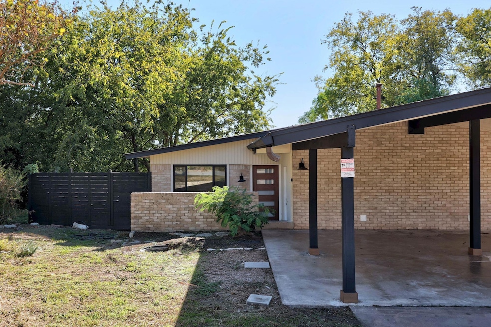 View of front of house featuring brick siding and a front yard