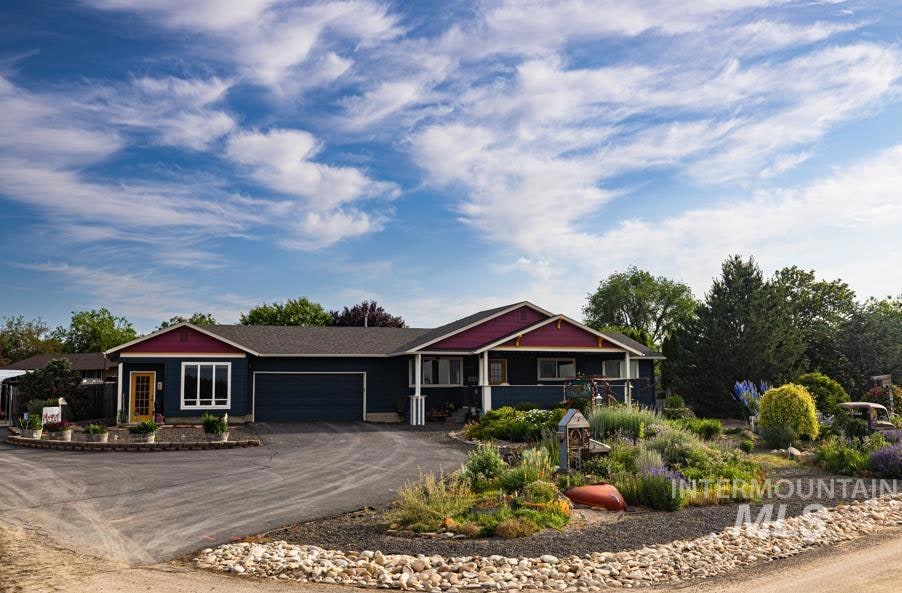 View of front of property featuring an attached garage and driveway