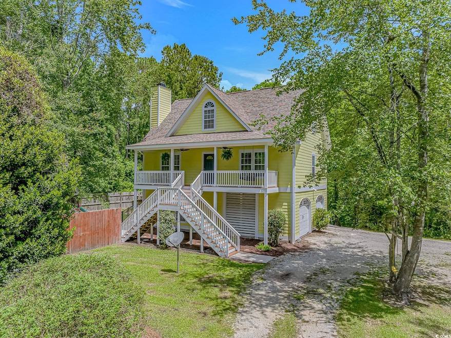 Beach home featuring covered porch, roof with shin