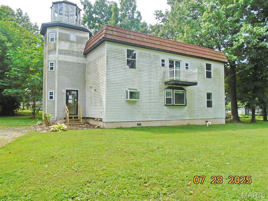 View of property exterior with entry steps, a yard, a balcony, crawl space, and mansard roof