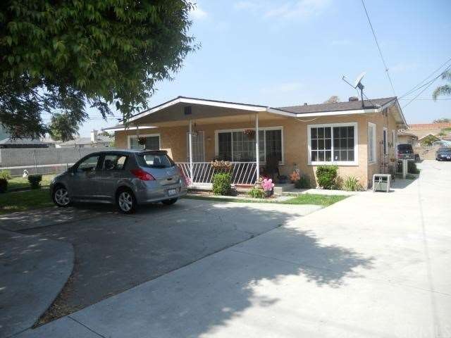 Front house with shade tree, porch and extra parking.
