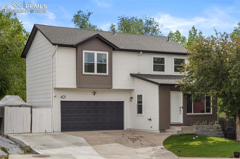 View of front of property featuring an attached garage, a shingled roof, and driveway