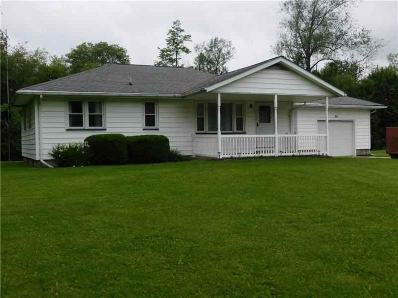 COUNTRY LOT WITH 1 CAR GARAGE AND COVERED PORCH