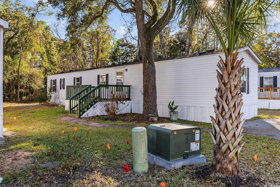 Manufactured / mobile home with a front lawn