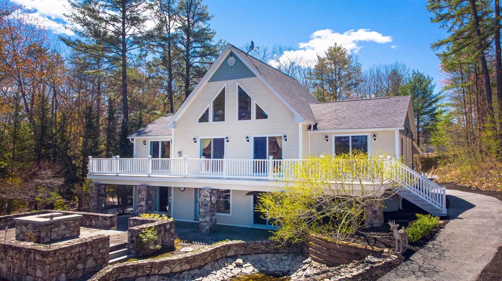 With large deck the length of house, custom patio,