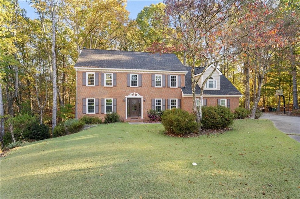 Colonial home featuring a front lawn