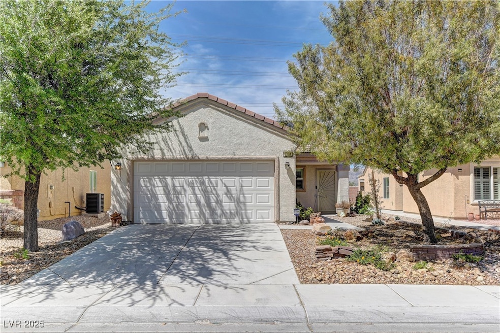 Ranch-style house featuring stucco siding, an atta