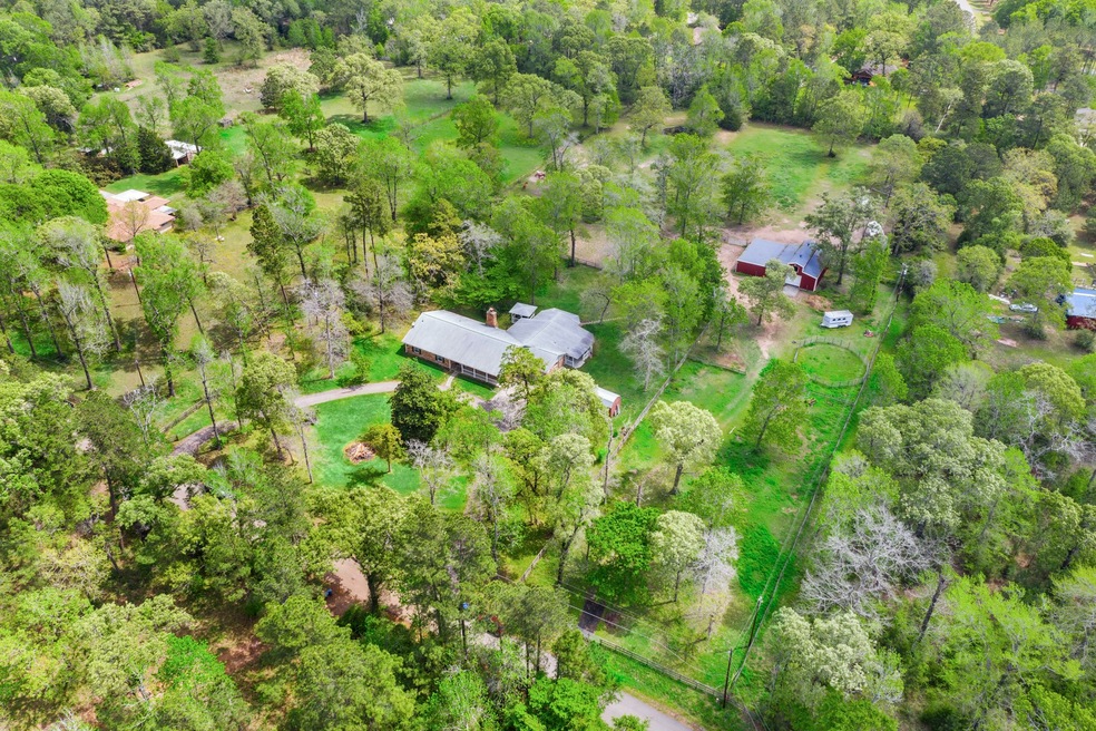 Beautiful 4.68 acre Magnolia, Texas property! Fully fenced and crossed fenced and ready for your horses and animals. 3 pastures, one arena and spring fed pond.