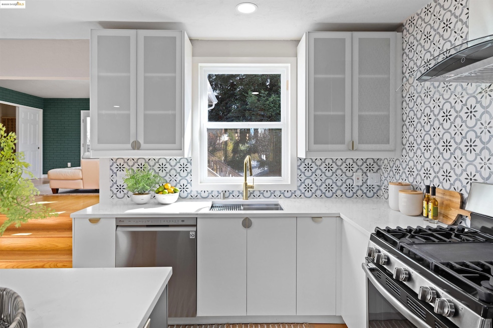 Kitchen featuring appliances with stainless steel finishes, light stone countertops, ventilation hood, white cabinetry, and glass insert cabinets