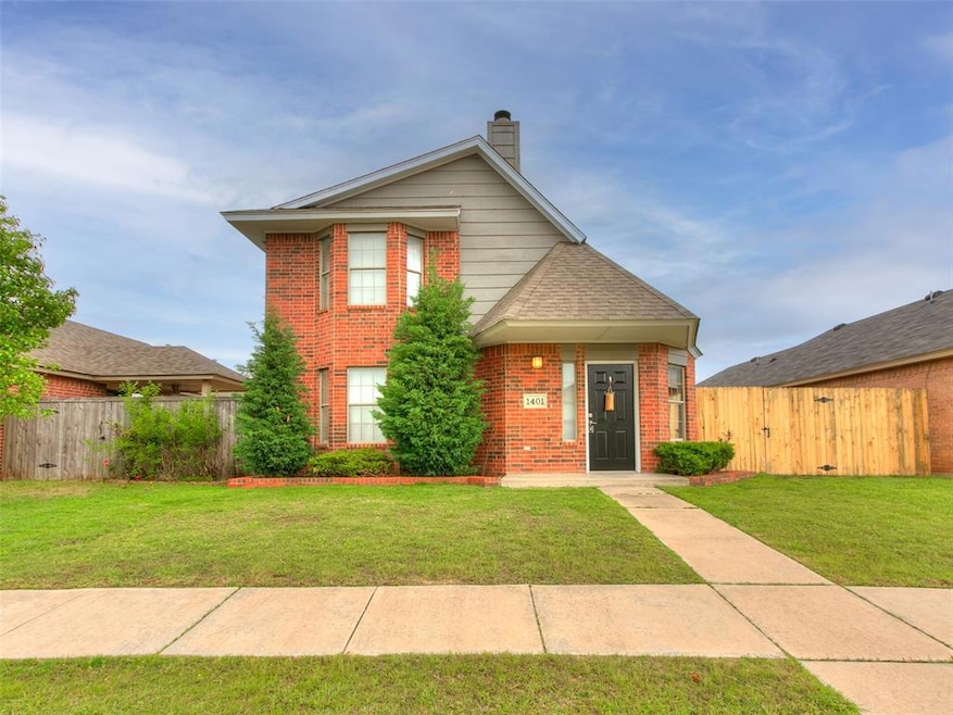 Traditional-style home with a front lawn, fence, a