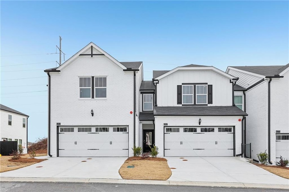 View of front of home with an attached garage, cen
