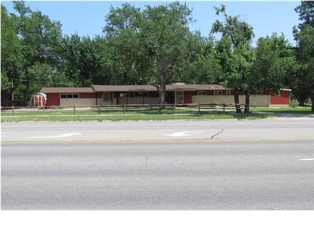 Sprawling ranch with paved circle drive off Maize 