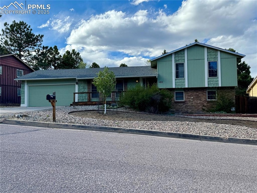 Tri-level home with brick siding, driveway, and a 