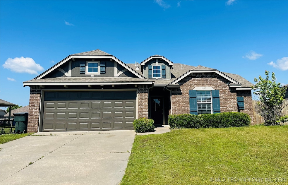 View of front of house with brick siding, driveway