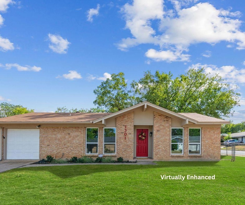 View of front of property with brick siding and a garage