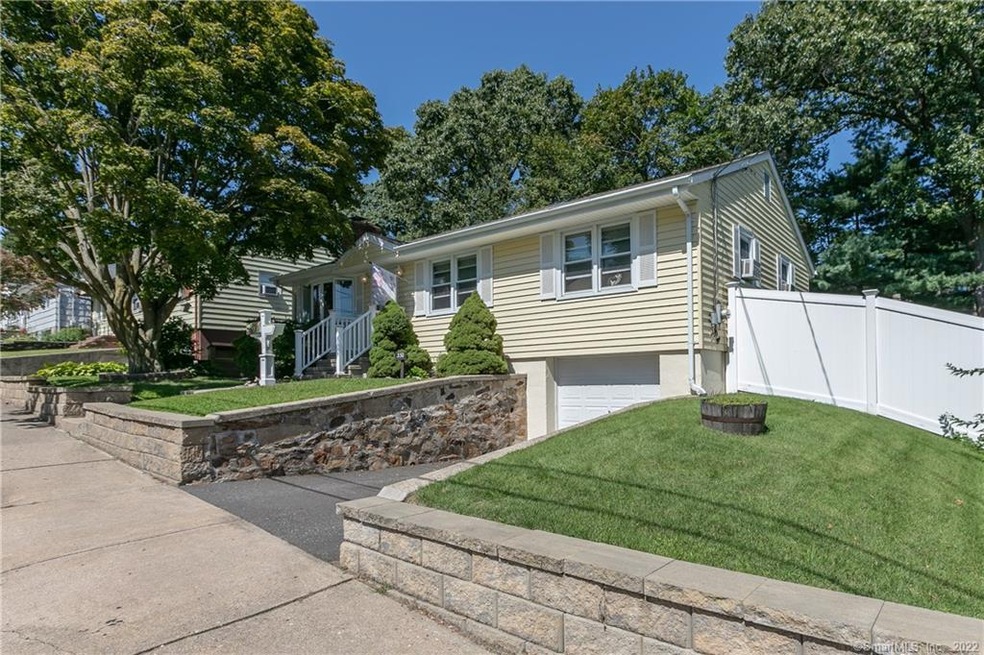 Front of house with 1 car attached under house and
