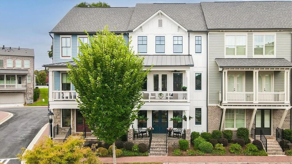 View of front facade with roof with shingles and a standing seam roof