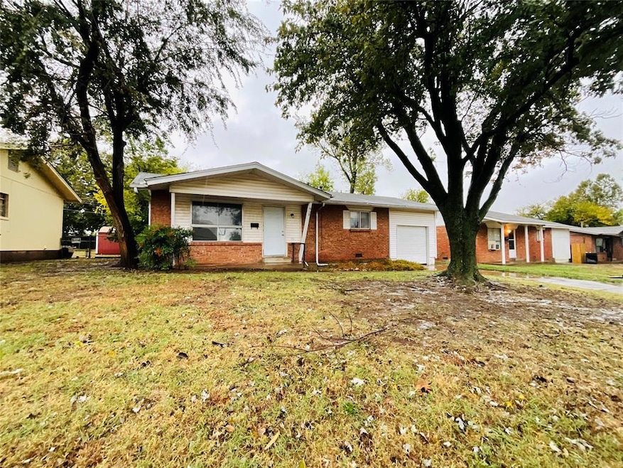 Single story home featuring a garage and a front l