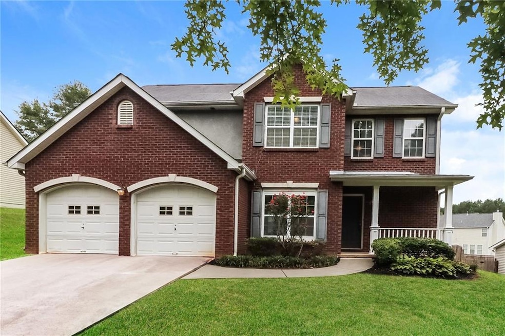View of front of home with a garage, covered porch