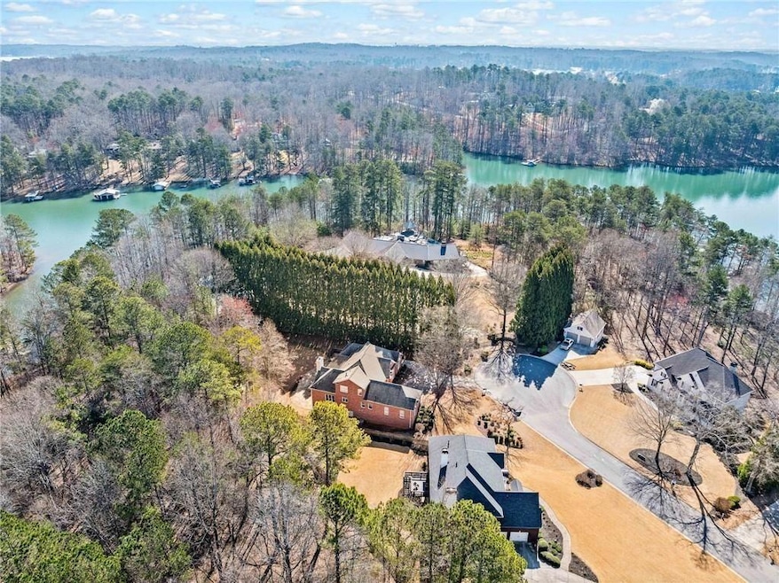 Drone / aerial view with a water view and a view of trees