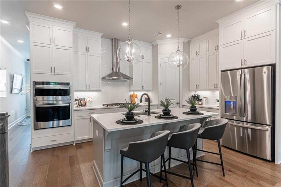 Gorgeous kitchen with white cabinets and willow grey island. All soft close doors and drawers!