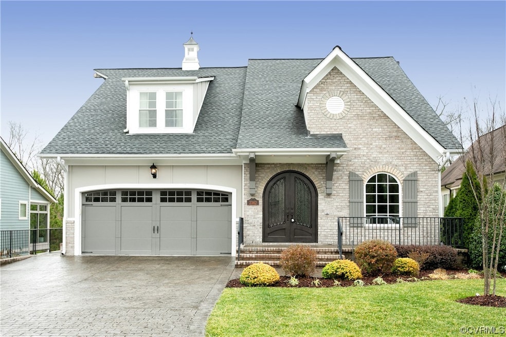 View of front of home with a front lawn and a gara