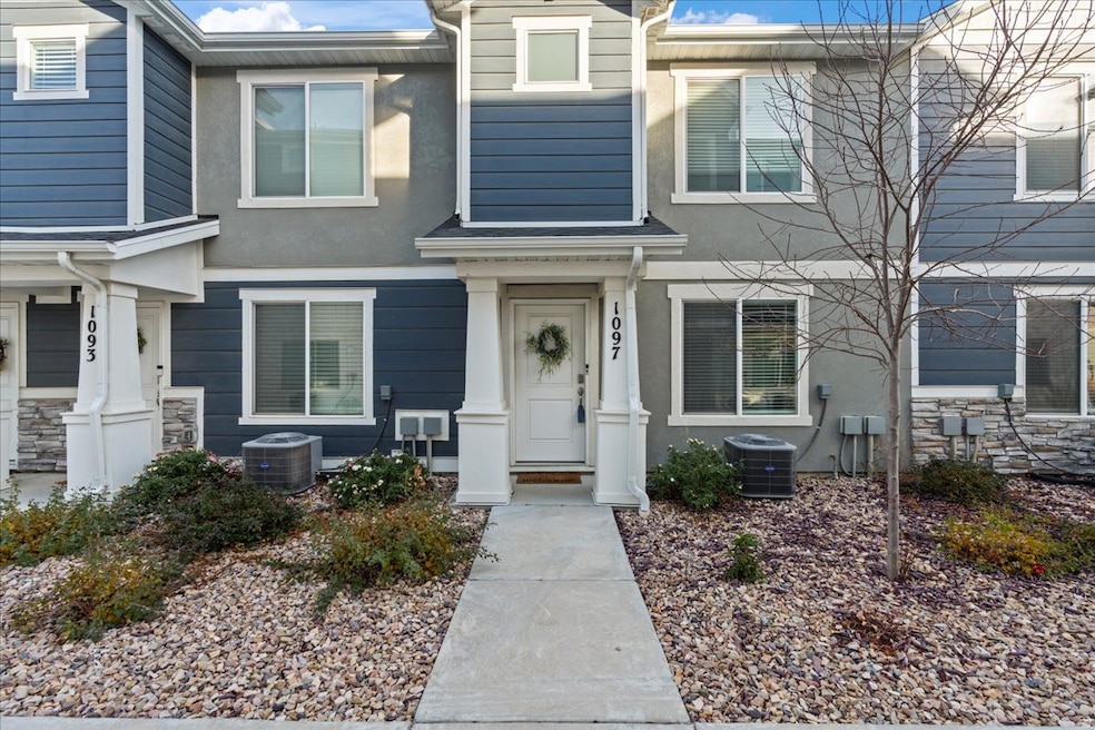 View of front of home featuring stucco siding and stone siding