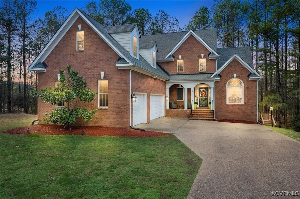View of property featuring a garage and a front ya