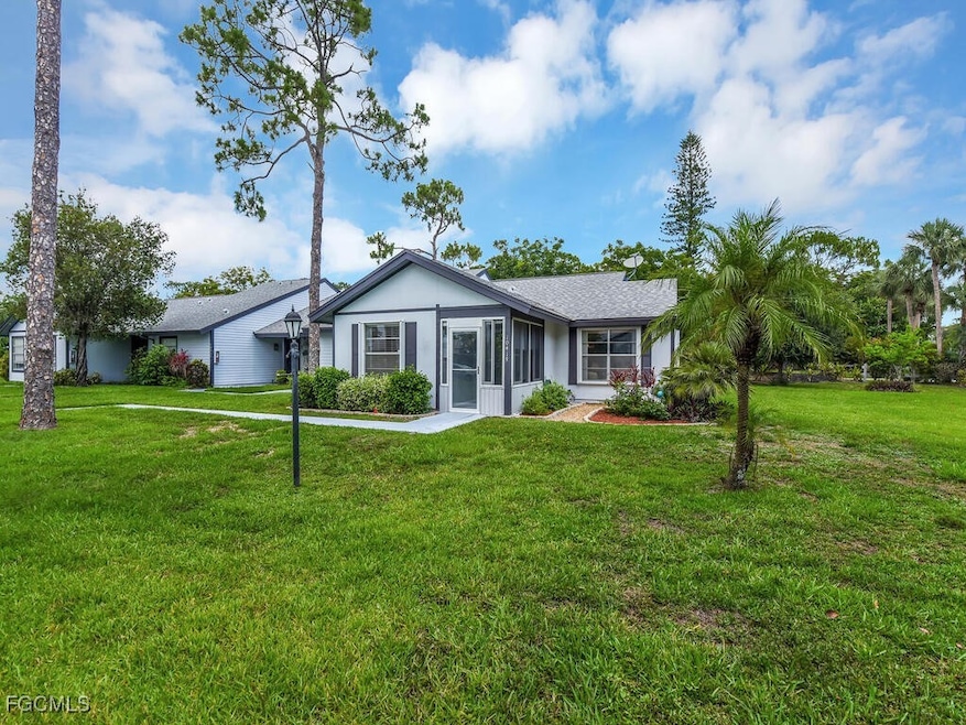 Ranch-style home featuring a front lawn, stucco si