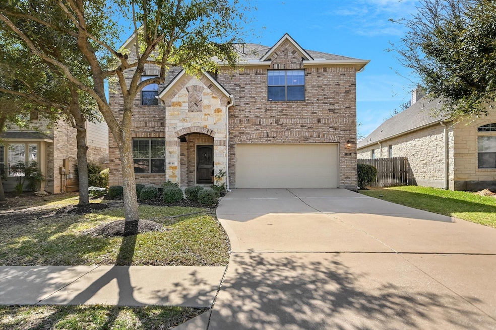 View of front facade featuring concrete driveway,