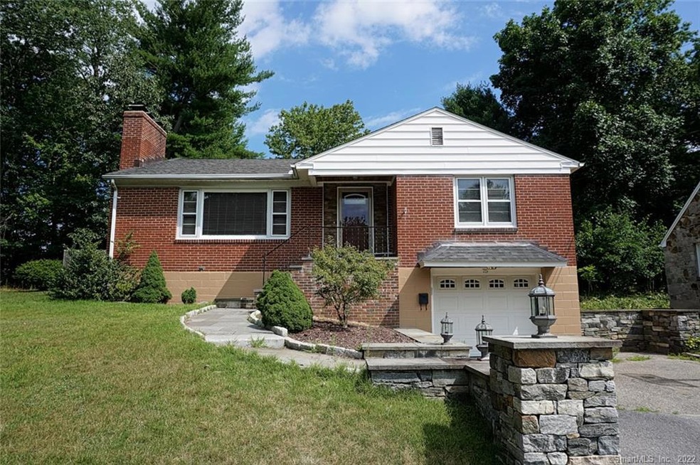 Great curb appeal with mature plantings, stone wal