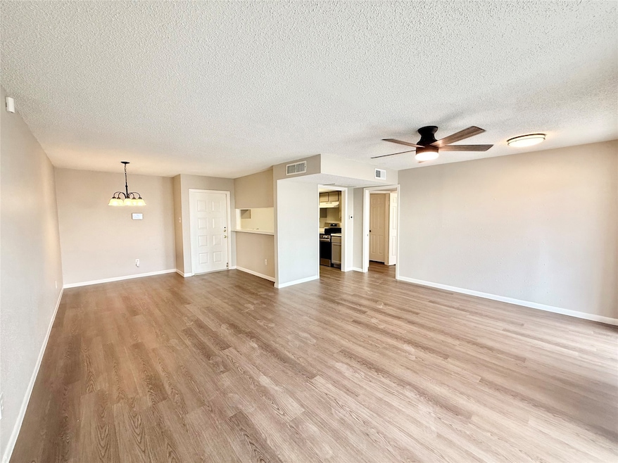 Open living space with new laminate flooring and l