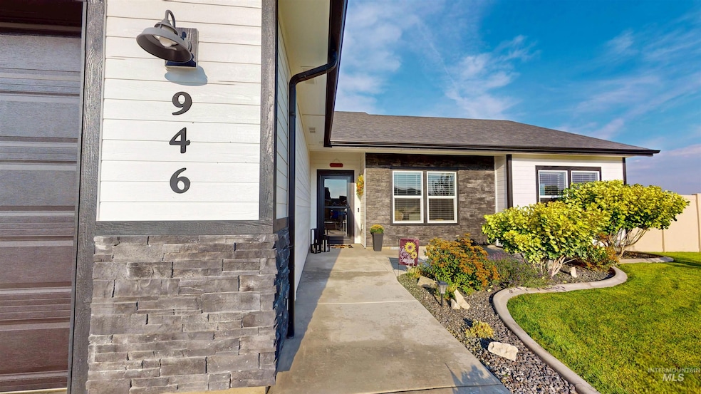 Doorway to property with a yard and a shingled roof