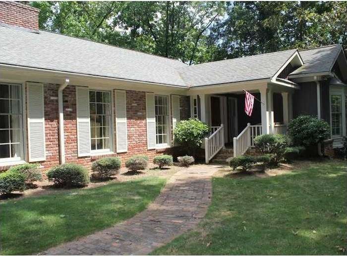 Exterior Front. Brick path leads to covered front 