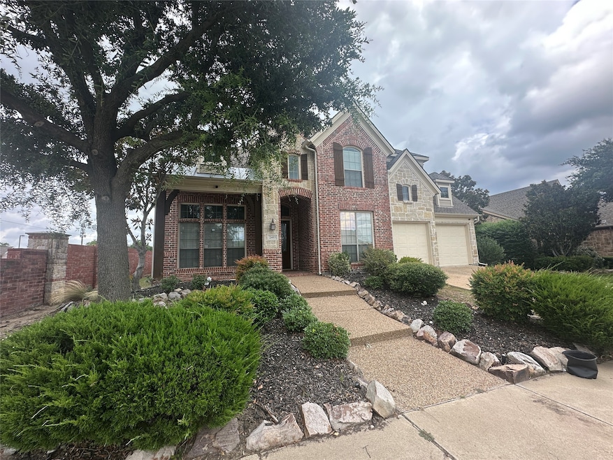 Traditional-style house featuring brick siding and concrete driveway