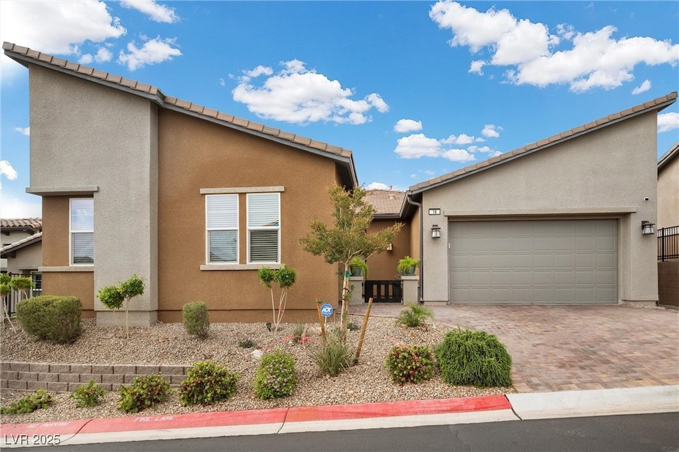View of front of house with stucco siding, an atta