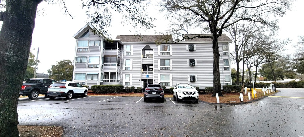 View of property with uncovered parking
