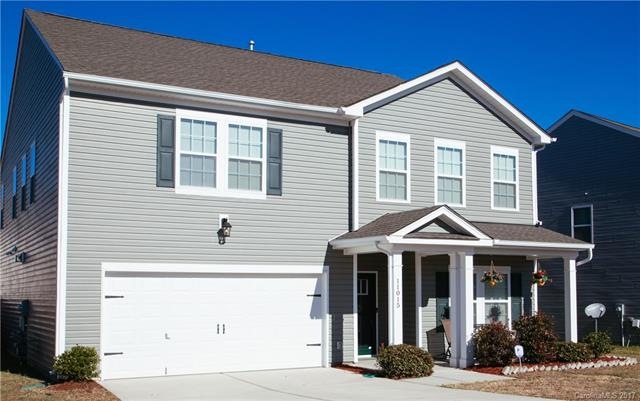 Front view of rocking chair porch, 2-car garage an