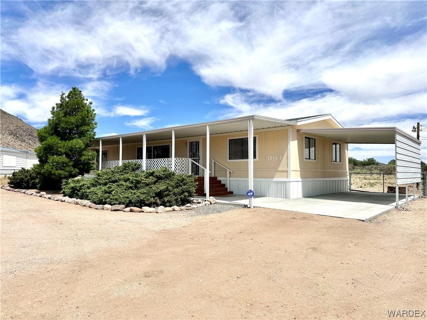 View of covered parking and entrance.