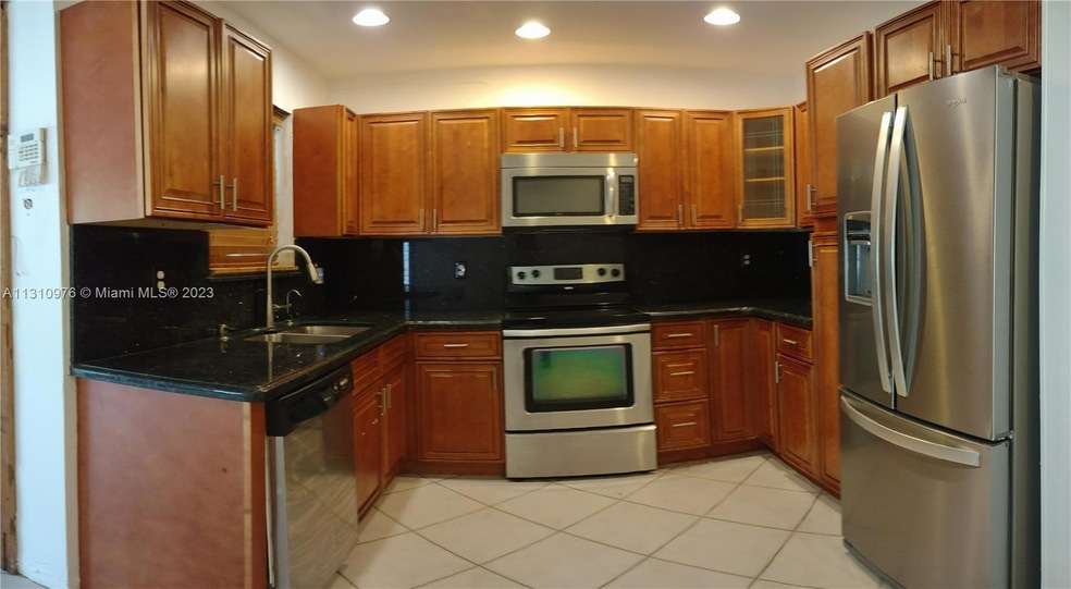 Wooden kitchen cabinets w/ granite countertop