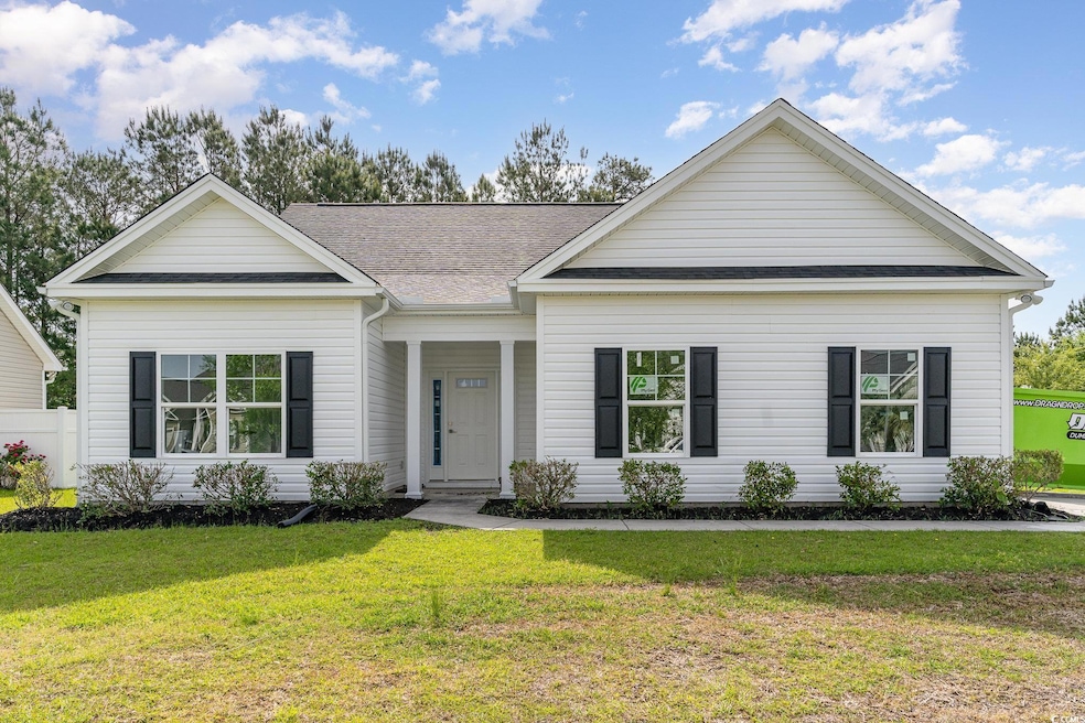 Ranch-style house with a shingled roof and a front