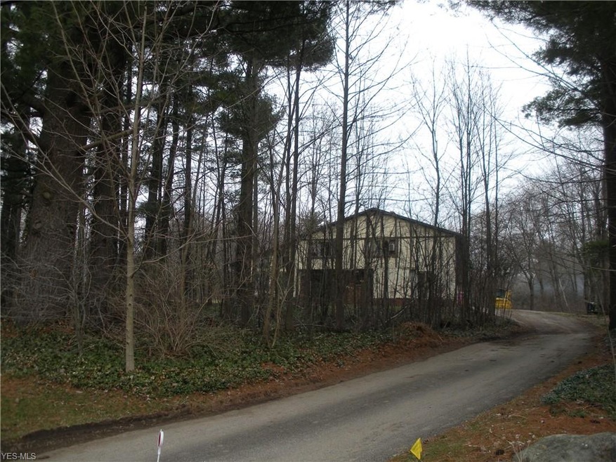 Front of home is wooded as well as side yard to ri