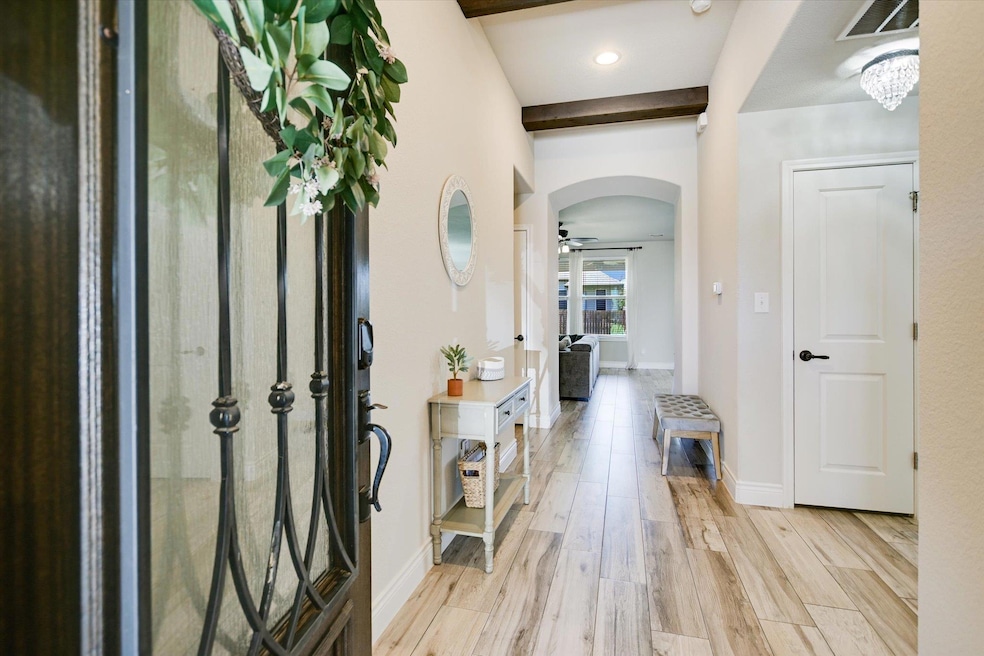 Foyer entrance with arched walkways, light wood-s