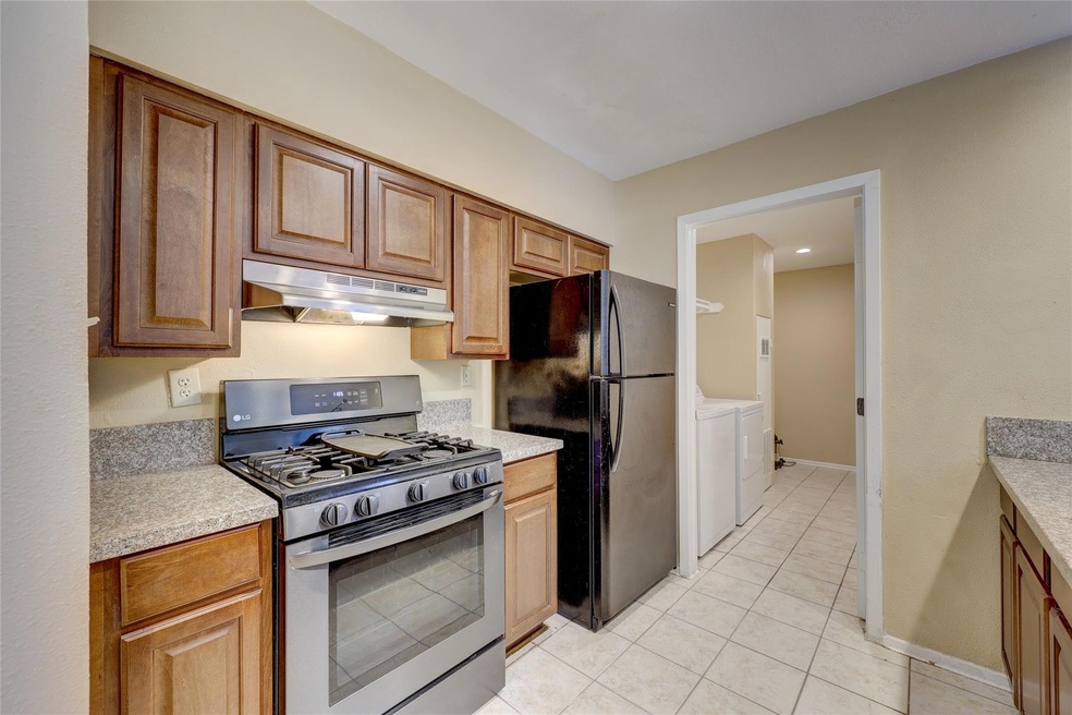 Kitchen with gas range, under cabinet range hood,